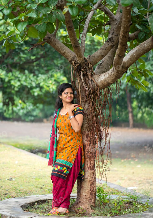 Preview: Beautiful girl between nature full of branches of tree.