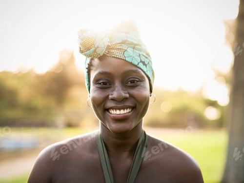 Preview: Portrait of happy African woman wearing colorful traditional turban