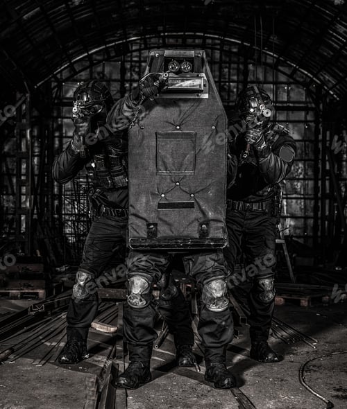 Preview: SWAT team members covering with ballistic shield
