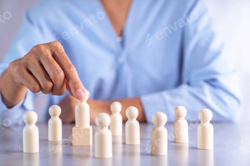 Vista previa: A businesswoman's hand is choosing a different level wooden puppet. to represent the selection of le