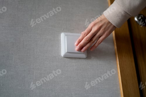 Preview: Hand Turning on a Light Switch, Illuminating a Room With the Flick of a Finger