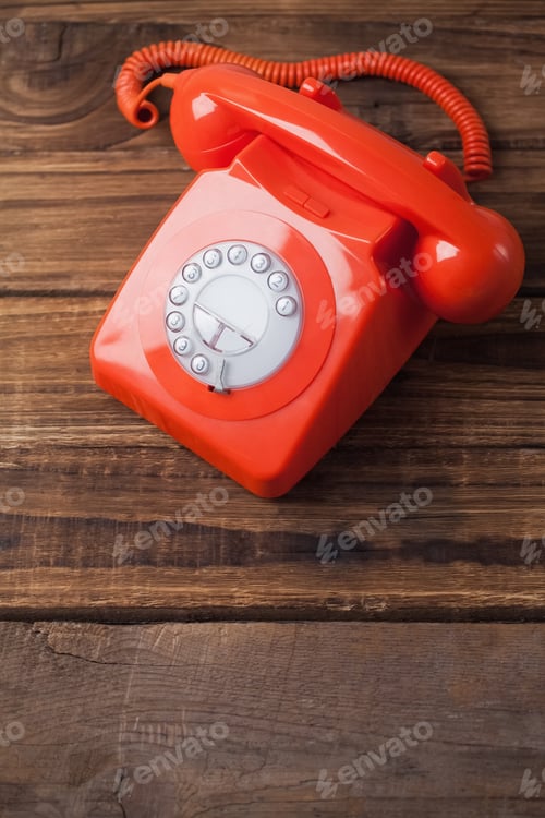 Preview: Red telephone on wooden table with copy space