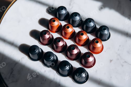 Preview: Set of colorful coffee capsules on round table