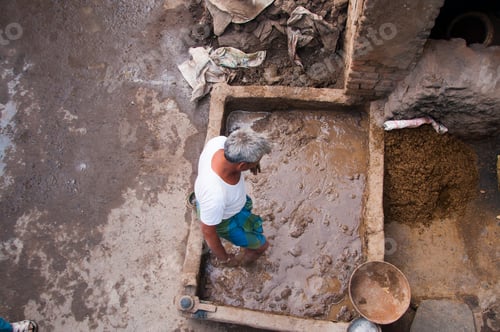 Preview: Potter preparing clay for making pots, India.