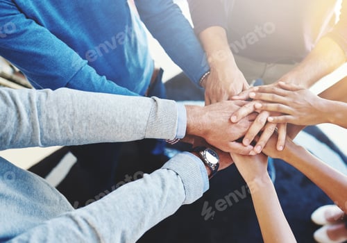 Preview: Cropped shot of a group of businesspeople standing in a huddle with their hands stacked