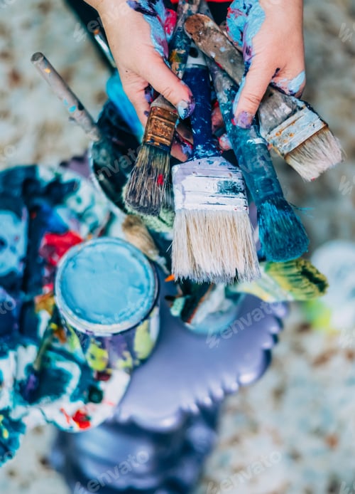 Preview: Artist hands holding brushes painting creating original art