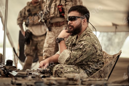 Preview: Soldiers in camouflage uniforms planning on operation in the camp