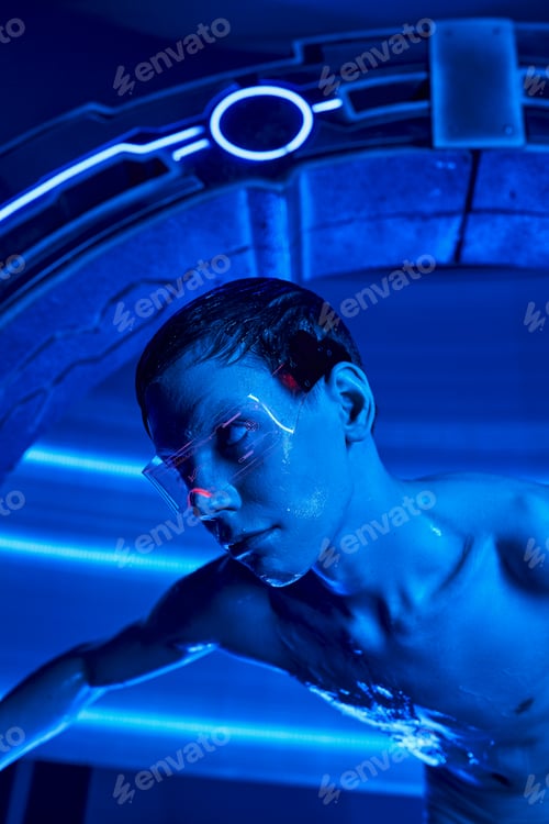Preview: scientific breakthrough, alien in goggles looking out experimental device in futuristic laboratory
