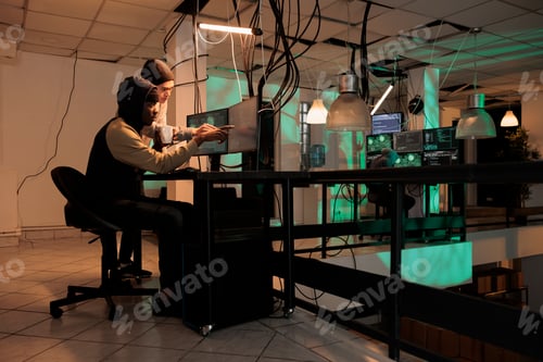 Preview: Team of cybercriminals fixing computer system cyberattack