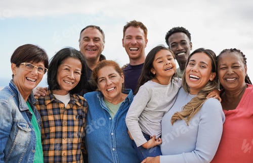 Preview: Group of multigenerational people hugging each other while smiling on camera