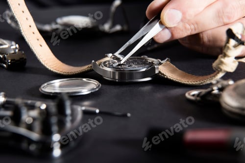 Preview: Detail of the work of a watchmaker who replaces a battery