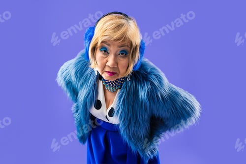 Preview: Happy and funny senior old woman on colorful background