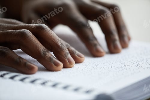 Preview: Man Reading Book in Braille Closeup