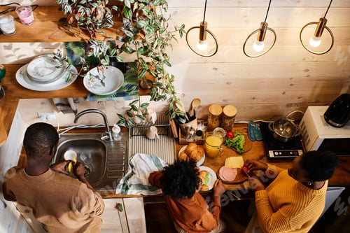 Preview: View of young African American family of three preparing food for breakfast