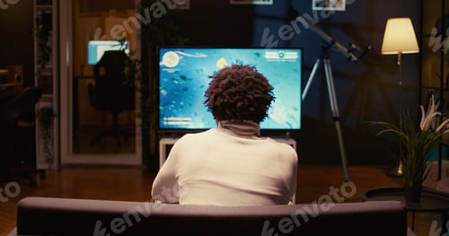Preview: Gamer playing classic arcade space shooter videogame on modern smart TV