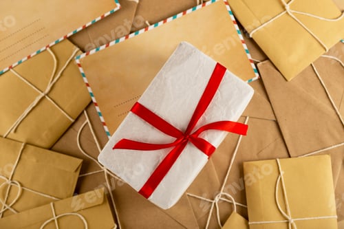 Preview: White minimal Christmas gift on lots of vintage craft envelopes and Santa letters.