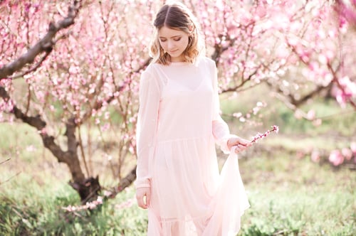 Preview: Beautiful blonde teenage girl in peach orchard outdoor