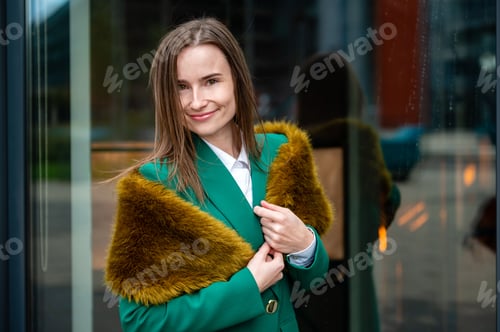 Preview: portrait of a business woman near a glazed building in the financial district
