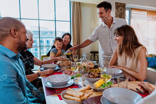 Preview: Family and friends reunion at home. Multi-generational family gathering having lunch at home