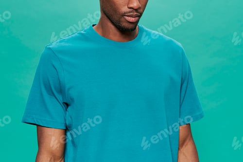 Preview: Anonymous african man with blue t-shirt with a turquoise background