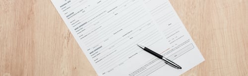 Preview: panoramic shot of print resume templates and pen on wooden table