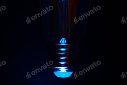 Preview: Light bulb on black background close up