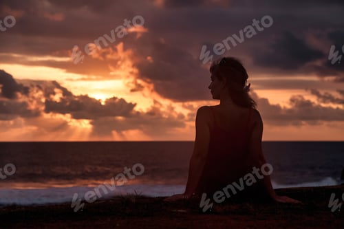 Preview: Middle age woman on tropical coast at sunset background