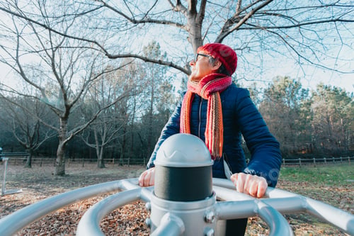 Preview: Old woman doing sport and exercise outdoors while looking away from camera. Doing activities