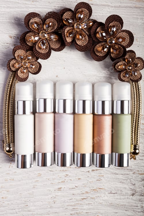 Preview: Bottles of cosmetics products over white wooden background