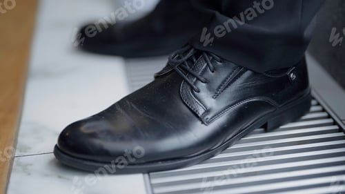 Preview: Black leather shoes. Action . Big dark elegant leather clean shoes taken off close .