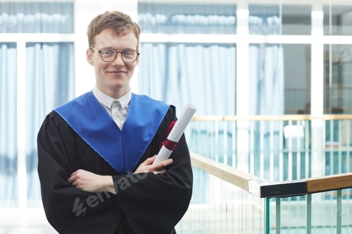 Proud Graduate Holding Diploma Indoors at School