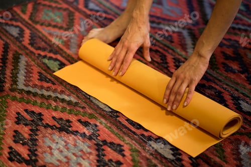 Preview: Woman rolling her mat after a yoga class