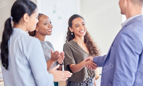 Preview: Shot of a young businesswoman shaking hands with a colleague in an office at work