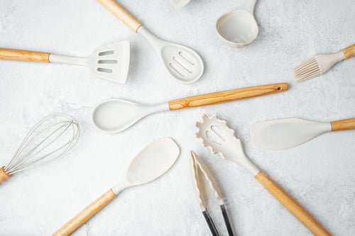 Preview: Kitchen utensils arranged on a light surface for culinary preparation