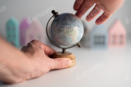 Preview: Old style World Globe. Mini colorful houses in the background