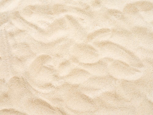 Preview: Beach sand background with natural wave pattern. Summer background of beach sand with small stones