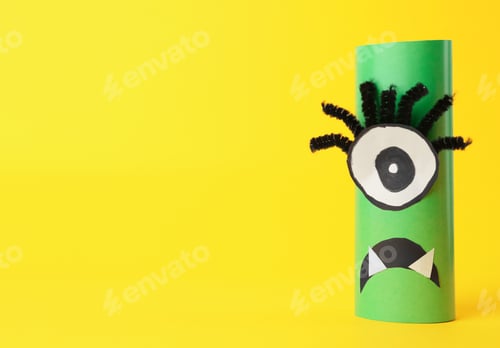 Preview: Funny green monster on yellow background, space for text. Halloween decoration