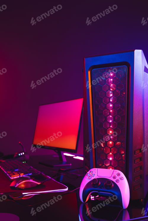Preview: Vertical image of computer with video game accessories with copy space on neon background