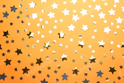 Preview: Confetti stars on orange background, flat lay. Christmas celebration