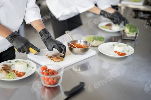 Preview: Cooks finishing main courses in the restaurant kitchen