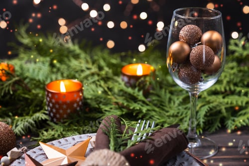 Preview: Christmas table setting with decorations, fir branches and candles.