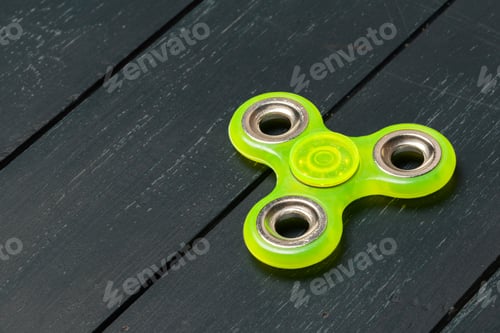 Preview: spinner on a wooden table. close up