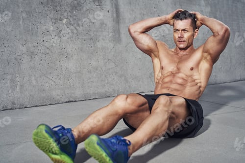 Preview: Male fitness model doing sit ups and crunches exercising abdominal muscles