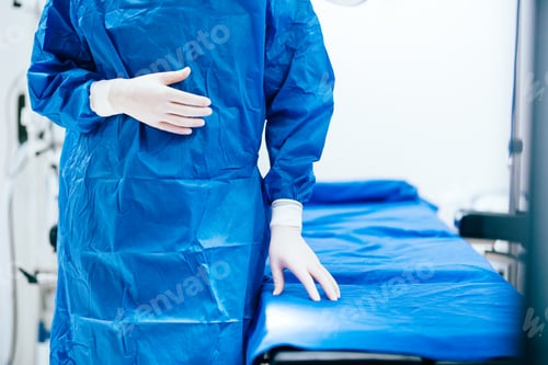 Preview: Medical Professional in Scrub Suit Next to Bed