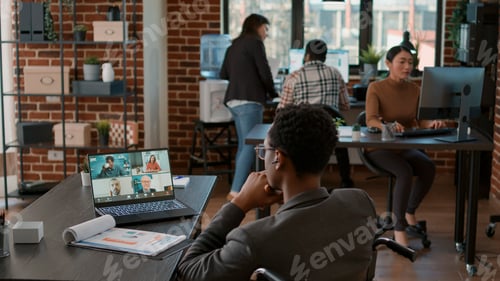 Preview: Young man talking to businesspeople on online teleconference