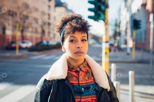 Preview: Cool young woman with pierced nose on city street, portrait