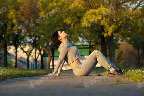 Preview: Sports woman sitting in park relaxing