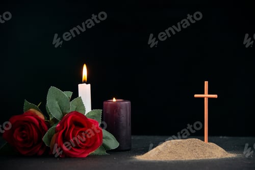 Preview: little grave with candle and flowers as memory on dark surface funeral israel death