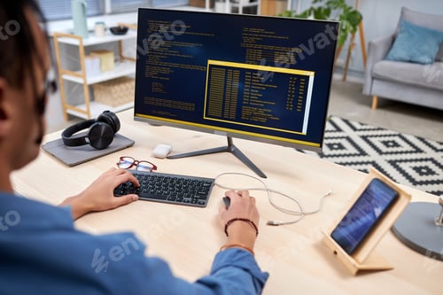 Preview: Young IT programmer writing code for mobile devices at home office workplace