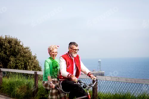Preview: Quirky couple sightseeing on tandem bicycle, Bournemouth, England